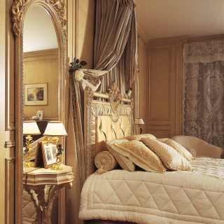 Big wall mirror with integrated night table, handmade carvings, white over gold finish as the capitonné bed