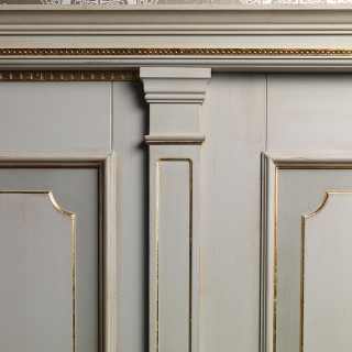 White lacquered boiserie with golden details and columns