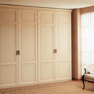 Modular classic wardrobe composed by double two doors elements with carvings, flower decorations, golden details