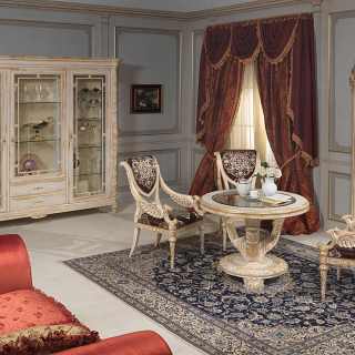 Living room Luigi XVI style: round table with carved chairs, glass showcase and wall mirror. All withe over gold finish, handmade carvings. White and Gold classic luxury furniture collection