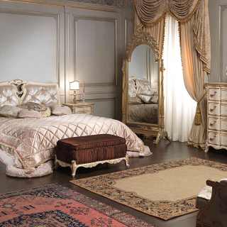 Furniture of bedroom Luigi XVI with capitonné headboard and carved furnishings, all in luxury classic style Luigi XVI